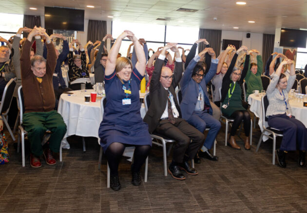 Participants at the event doing chair exercises