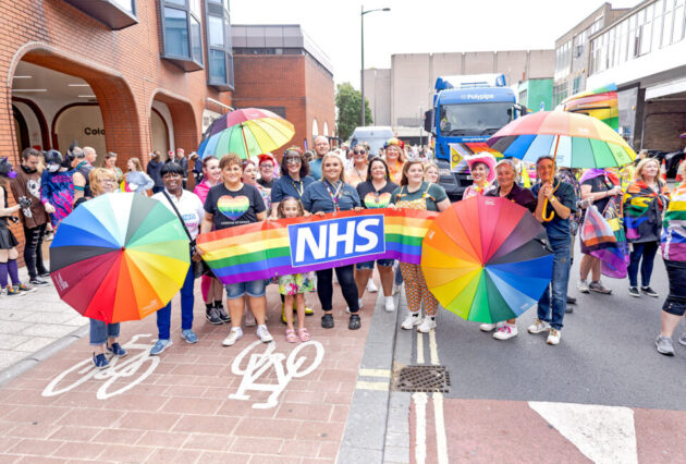 Colleagues at an event in Doncaster holding up a rainbow NHS pride flag
