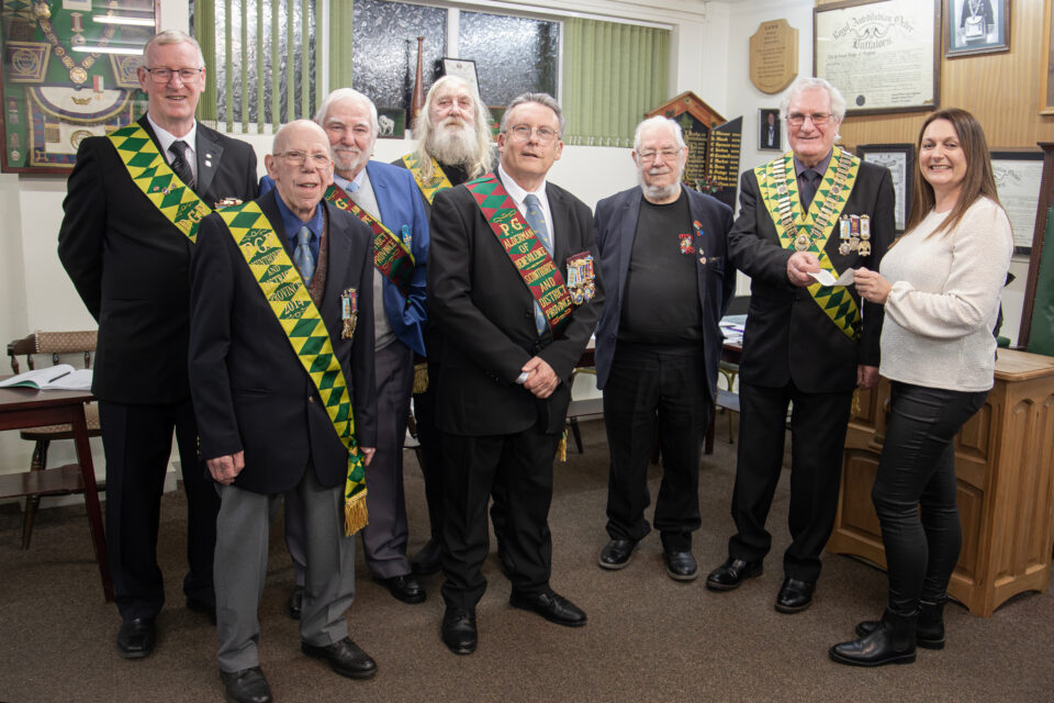 Seven members of the Scunthorpe and District Provincial Grand Lodge presenting cheque to Lindsay Clague