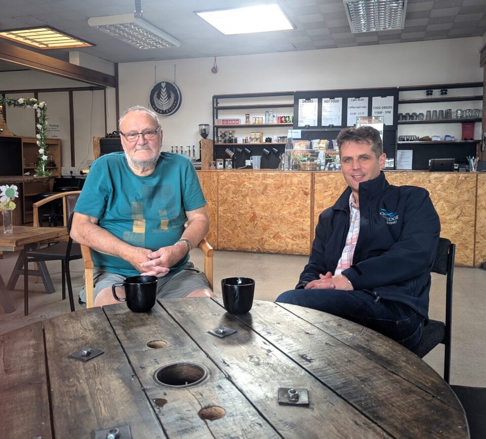 Two people sat at a café table