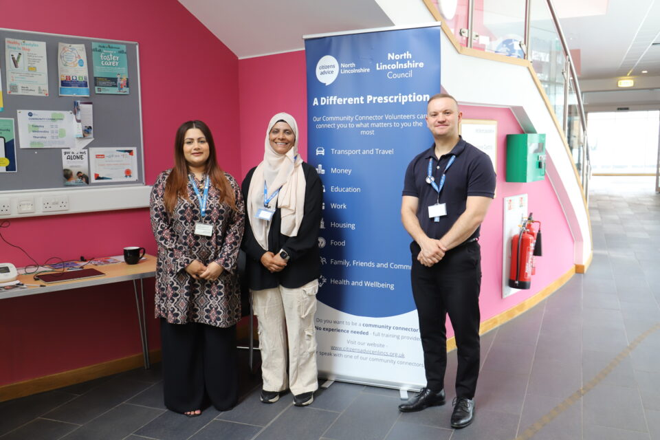 Three people standing and smiling