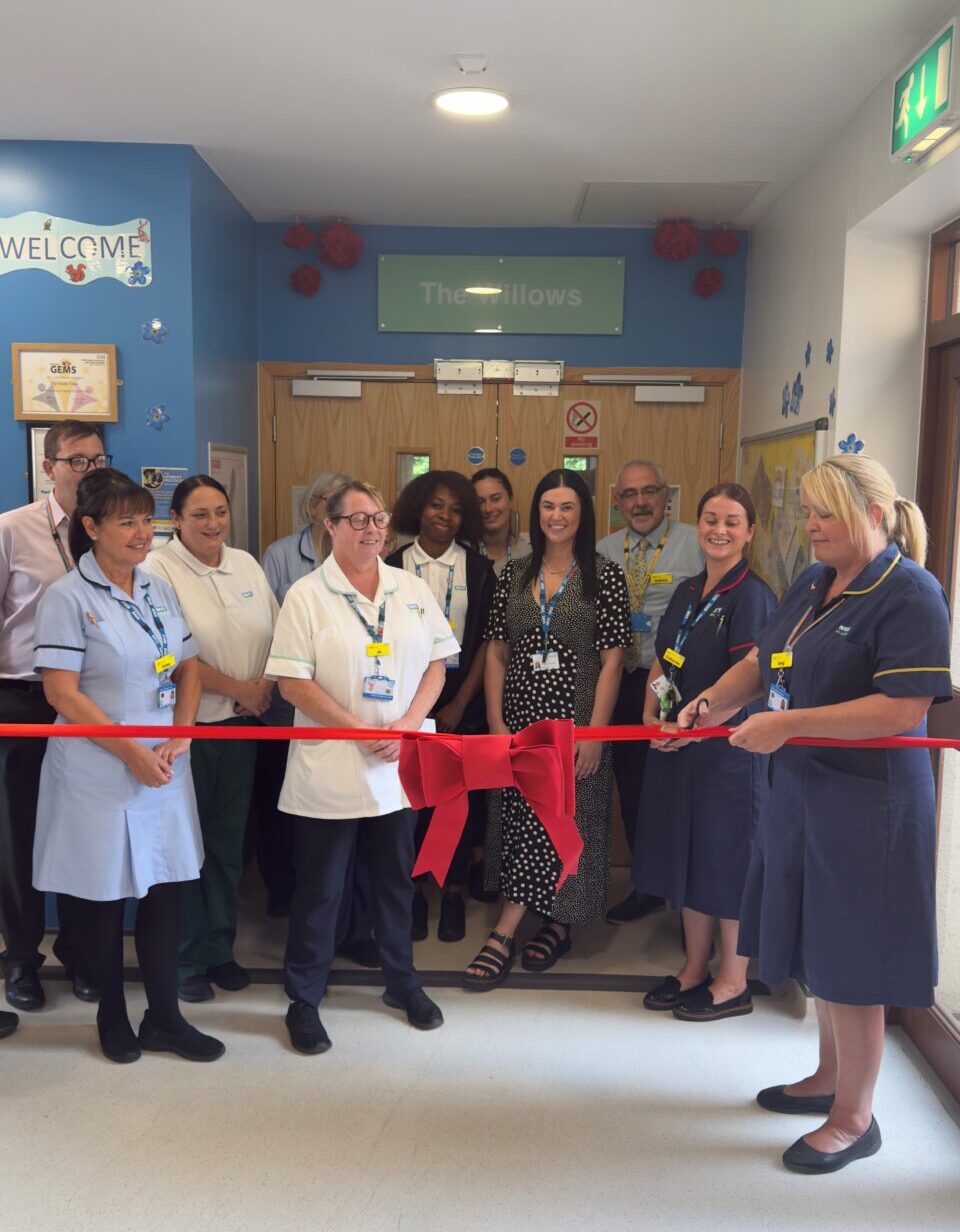Staff cutting a ribbon to open the Willows ward