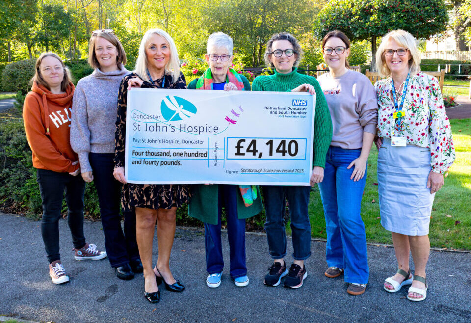 Sprotbrough Scarecrow Festival team holding £4,140 cheque
