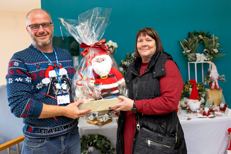 Man presenting woman with a Christmas Hamper