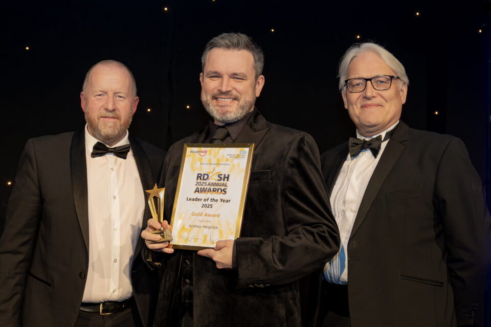 Dr Andrew Heighton with award