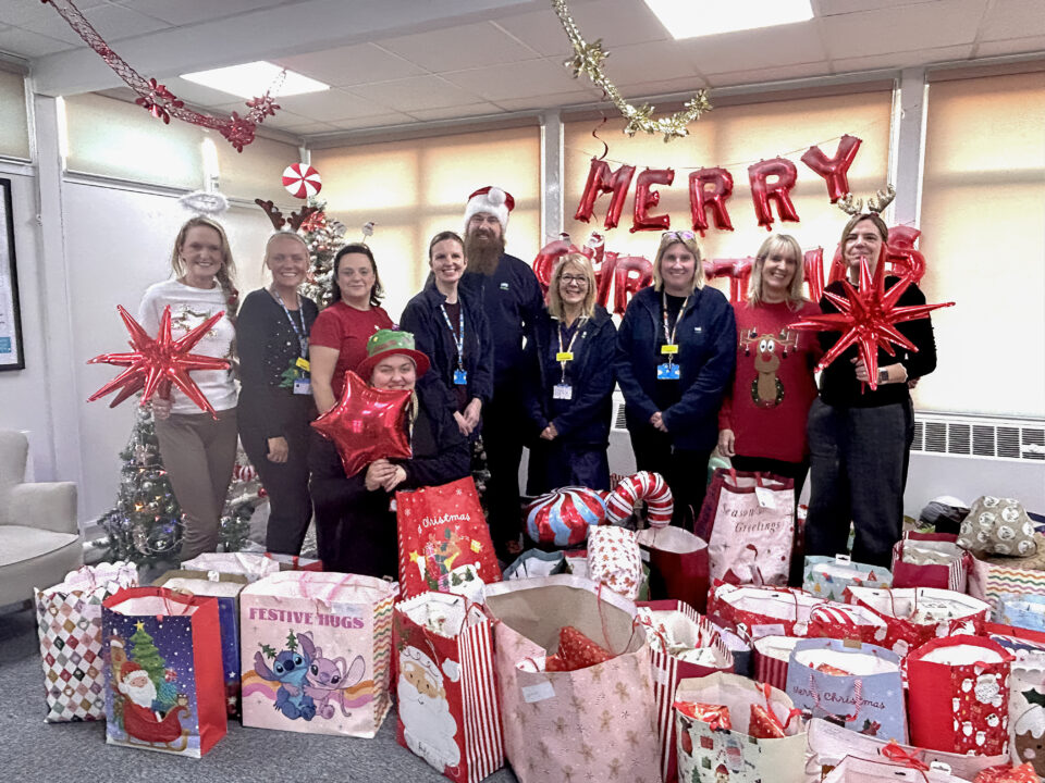 Children’s Care Group and the Children in Care team surrounded by presents