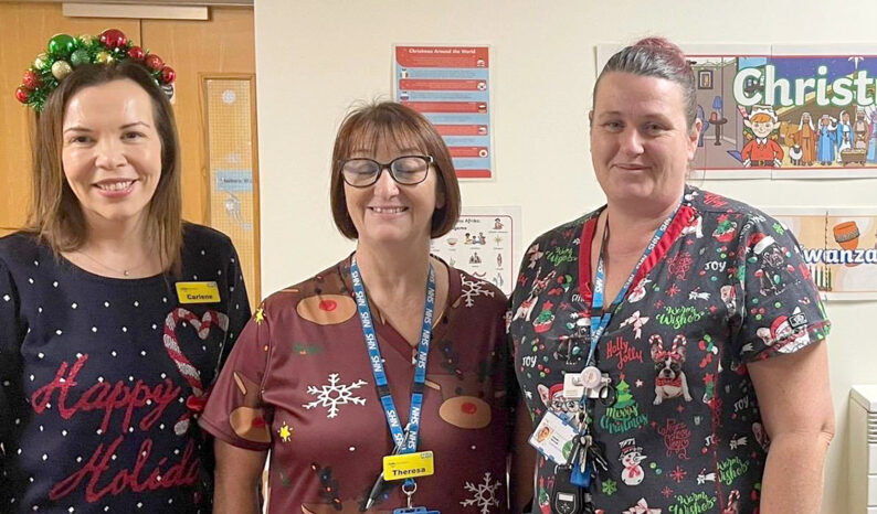 Three people in Christmas clothing