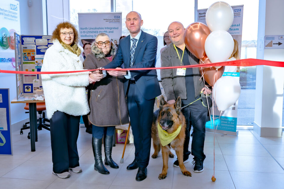 People cutting a red ribbon in the Elizabeth Quarter building