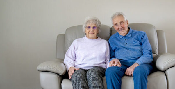 Two people sat on a sofa