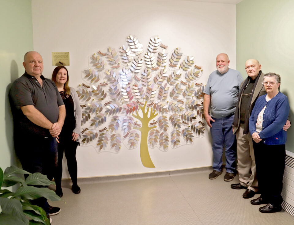People stood around memory tree