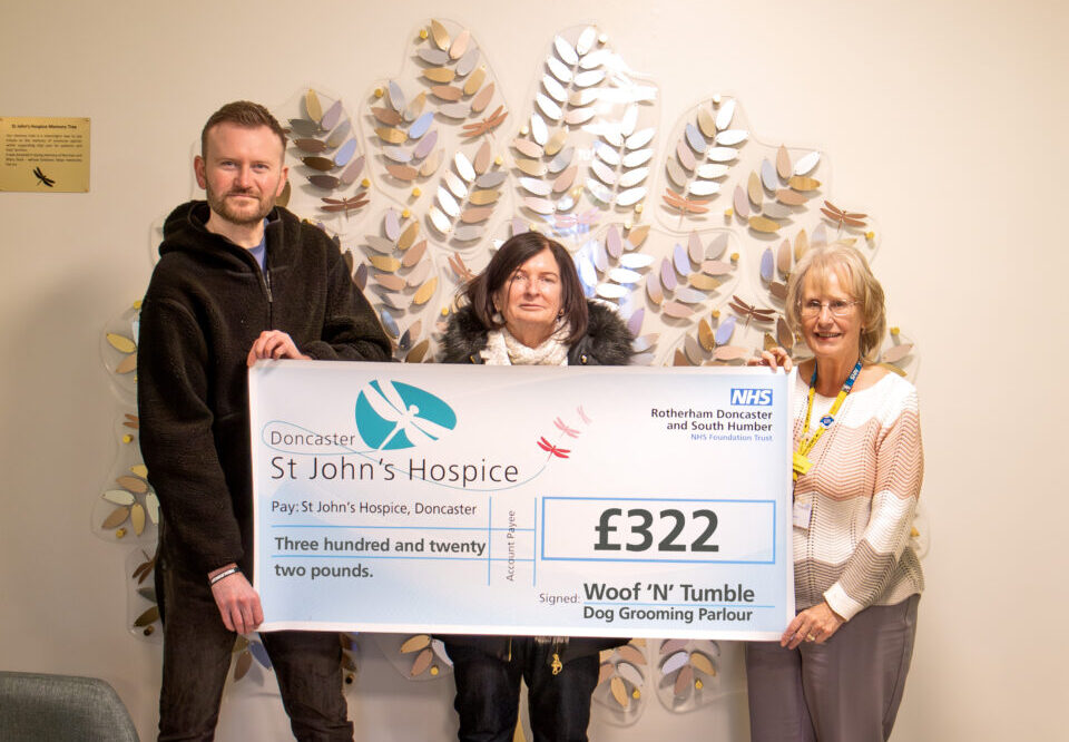 People holding a £322 cheque