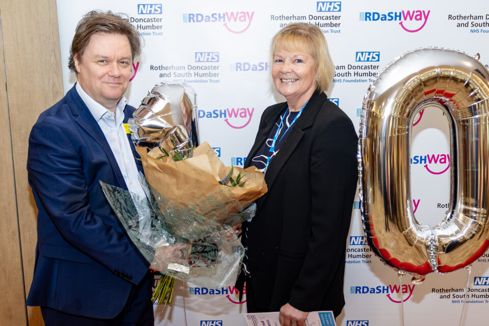 Toby Lewis accepting the flowers from Michelle Bridgewater
