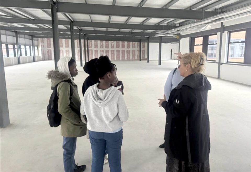 Young people stood in an empty building